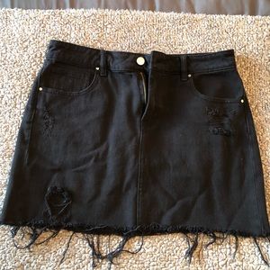 Black denim skirt with rip detail